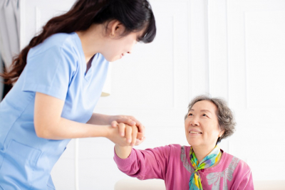 caregiver holding senior woman